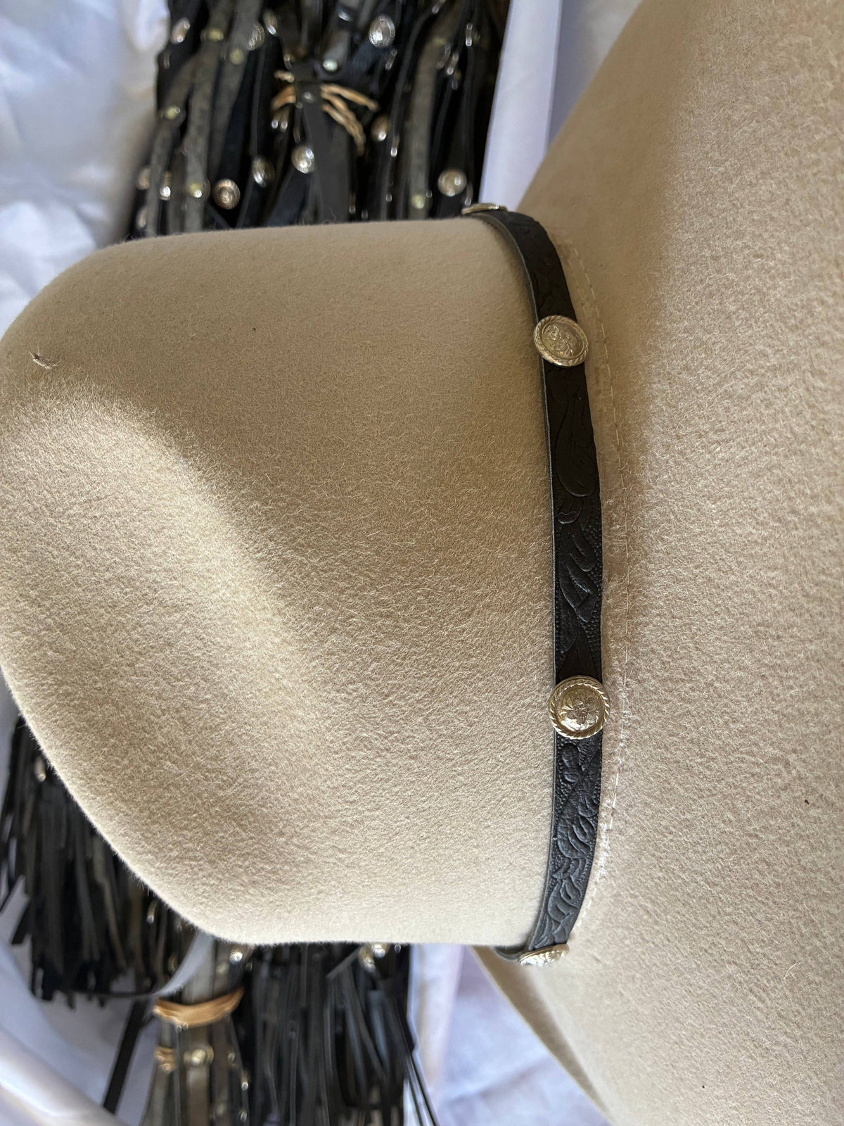 Adjustable black leather hatband with silver conchos