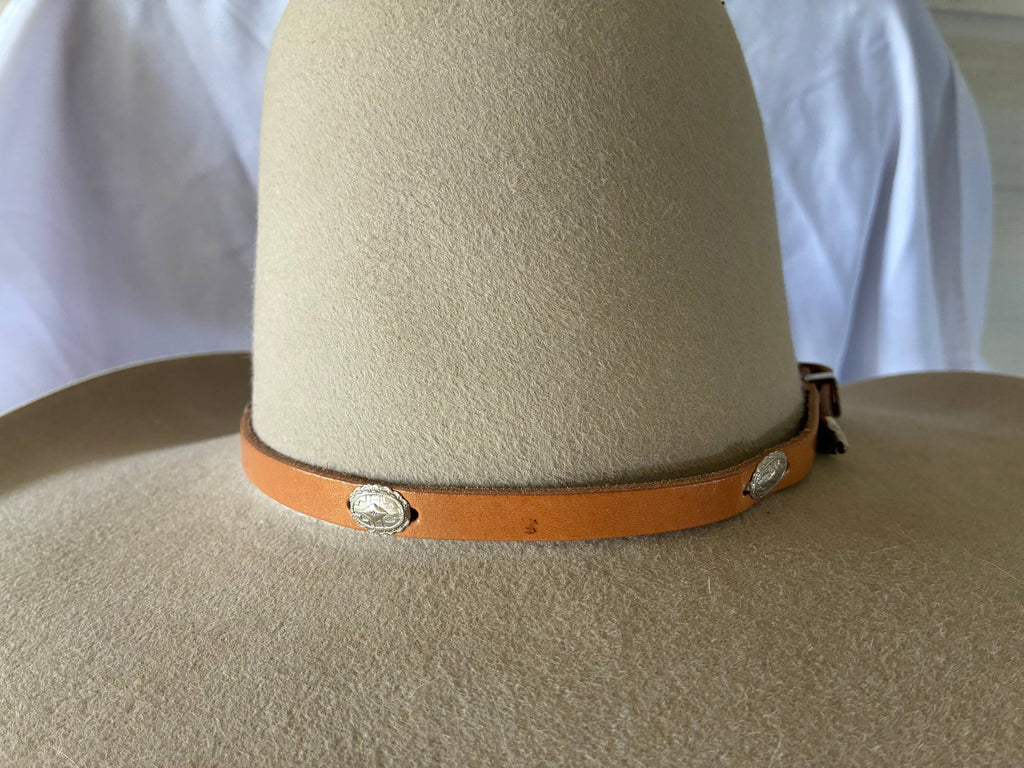 Adjustable tan leather hatband w/ silver 
Conchos & buckle
