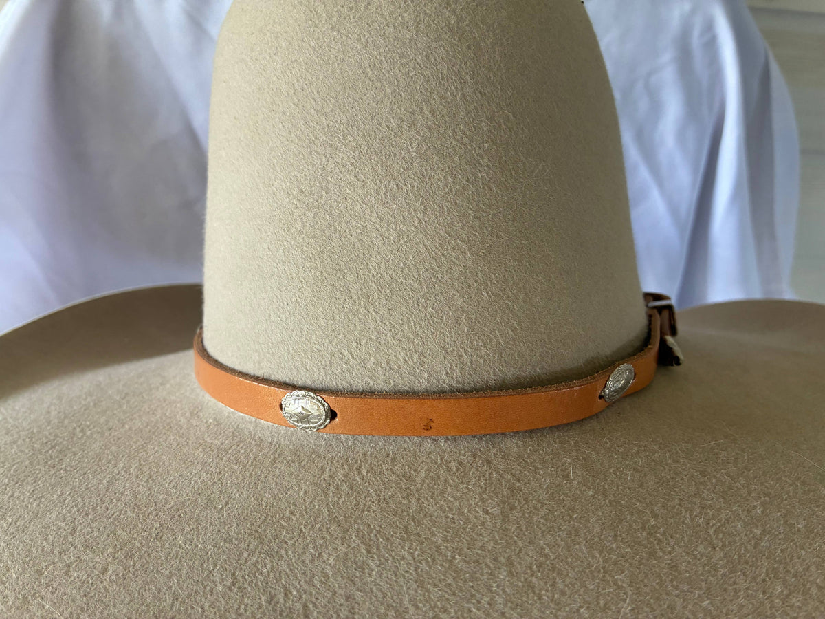 Adjustable tan leather hatband w/ silver 
Conchos & buckle